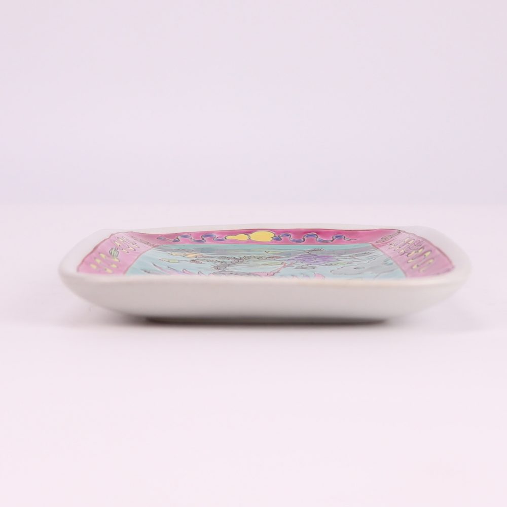 A rectangular ceramic fruit bowl with phoenix and peony design on a green background, side view